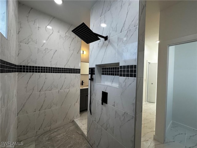 bathroom featuring walk in shower and vanity