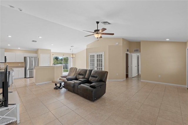 living room with light tile patterned floors, vaulted ceiling, baseboards, and ceiling fan with notable chandelier