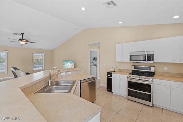 kitchen featuring stainless steel appliances, light countertops, visible vents, and a sink