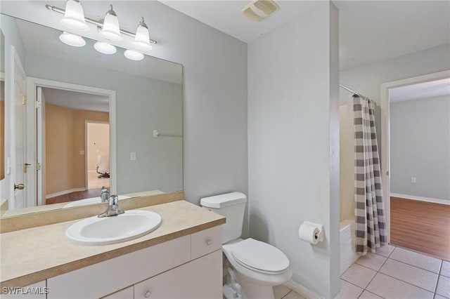 bathroom featuring toilet, vanity, visible vents, and tile patterned floors