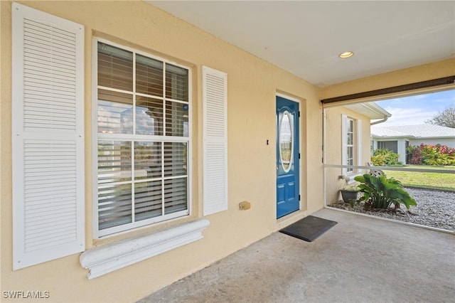 entrance to property with stucco siding