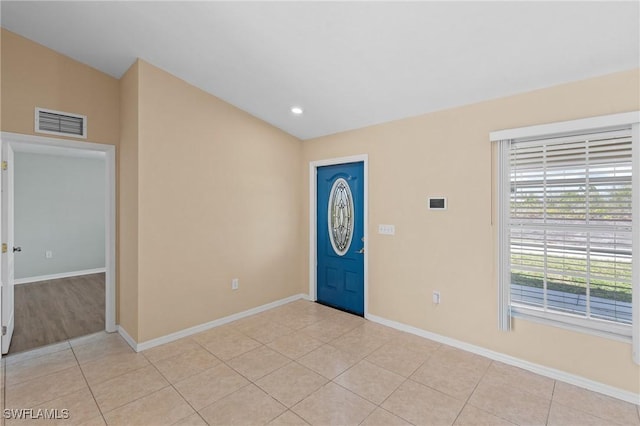 foyer entrance with recessed lighting, visible vents, light tile patterned flooring, vaulted ceiling, and baseboards