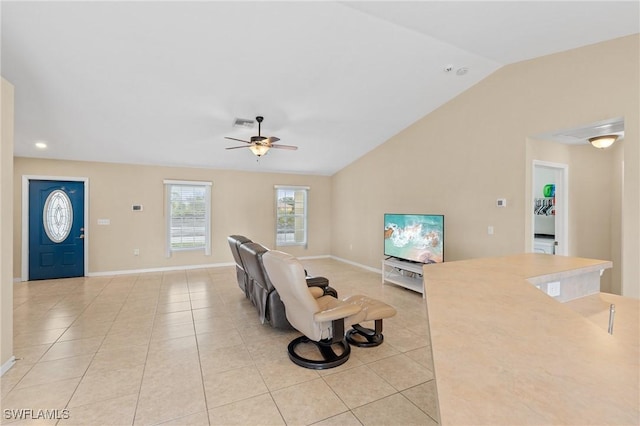 living room with light tile patterned floors, visible vents, baseboards, a ceiling fan, and lofted ceiling