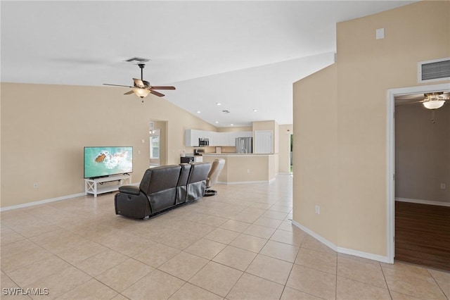 living room with lofted ceiling, visible vents, ceiling fan, and light tile patterned floors