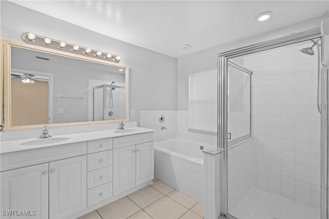 full bathroom featuring tile patterned flooring, a sink, a bath, and a shower stall