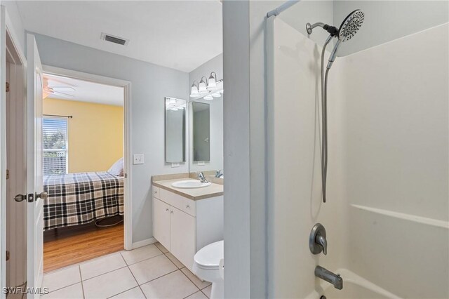 ensuite bathroom with ensuite bathroom, tile patterned flooring, visible vents, vanity, and shower / washtub combination