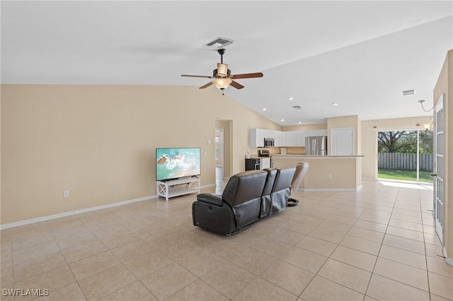 living area featuring light tile patterned floors, visible vents, a ceiling fan, vaulted ceiling, and baseboards