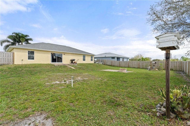 view of yard featuring an outdoor fire pit and a fenced backyard