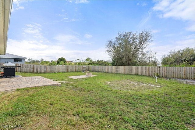 view of yard with a patio area and a fenced backyard