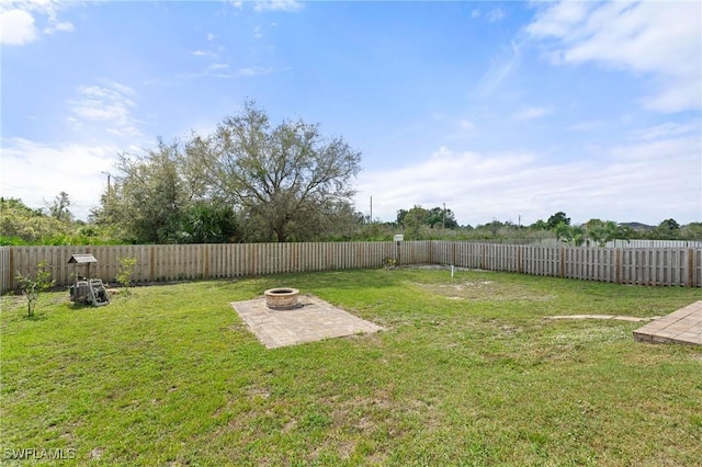 view of yard with a patio area, an outdoor fire pit, and a fenced backyard