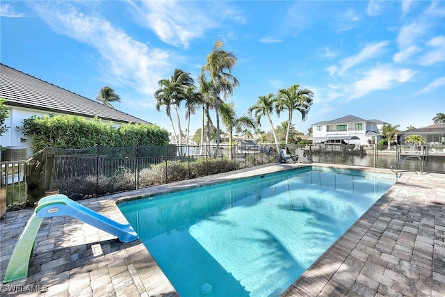 view of swimming pool featuring a water view and a water slide