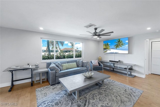 living room with ceiling fan and light hardwood / wood-style floors