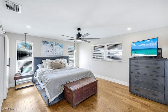 bedroom with ceiling fan and light wood-type flooring