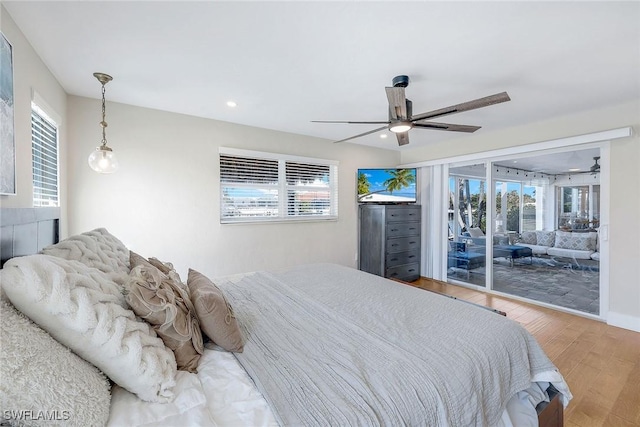 bedroom featuring hardwood / wood-style flooring, ceiling fan, and access to outside