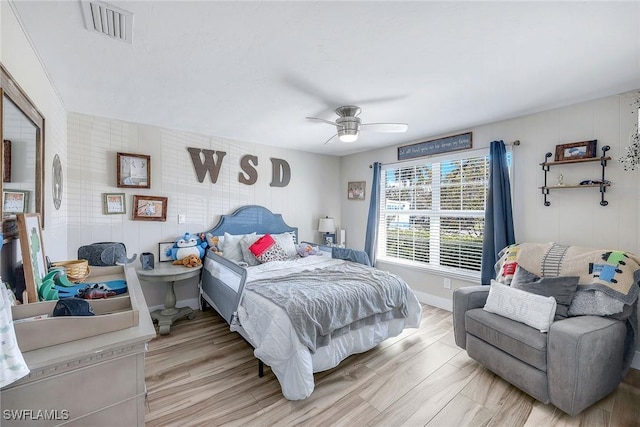 bedroom with light hardwood / wood-style floors and ceiling fan