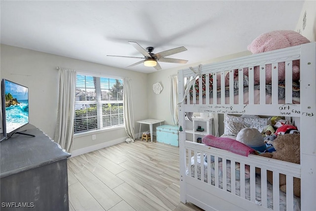 bedroom with light hardwood / wood-style flooring and ceiling fan