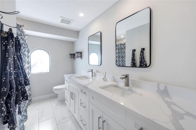 bathroom featuring vanity and toilet