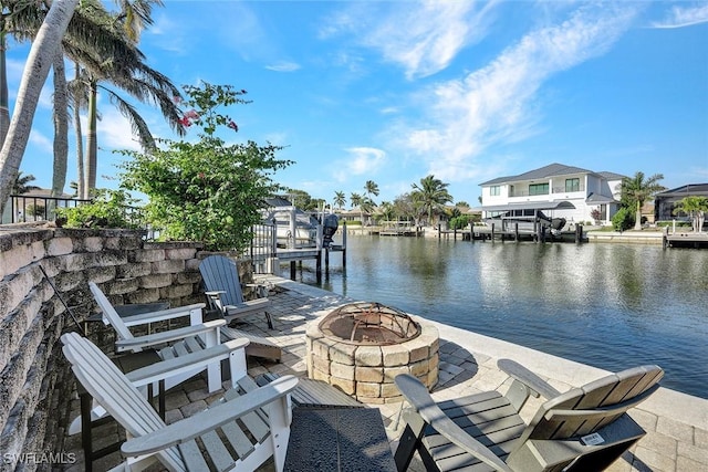 view of dock with a water view and an outdoor fire pit