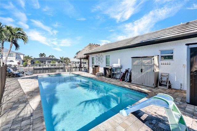 view of swimming pool featuring a water view and a water slide