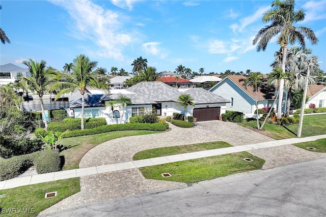 view of front of property with a garage and a front yard