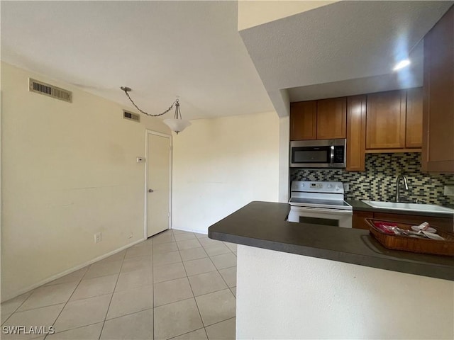 kitchen with electric stove, sink, tasteful backsplash, and light tile patterned floors