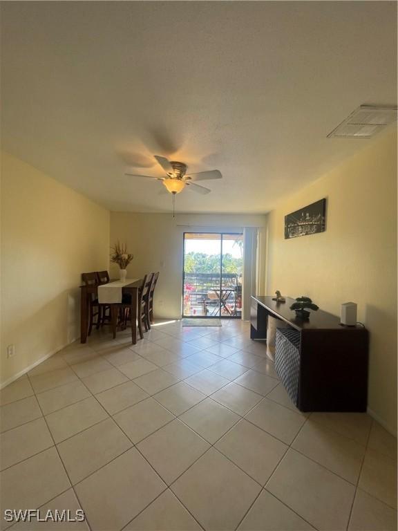 dining area with light tile patterned floors and ceiling fan