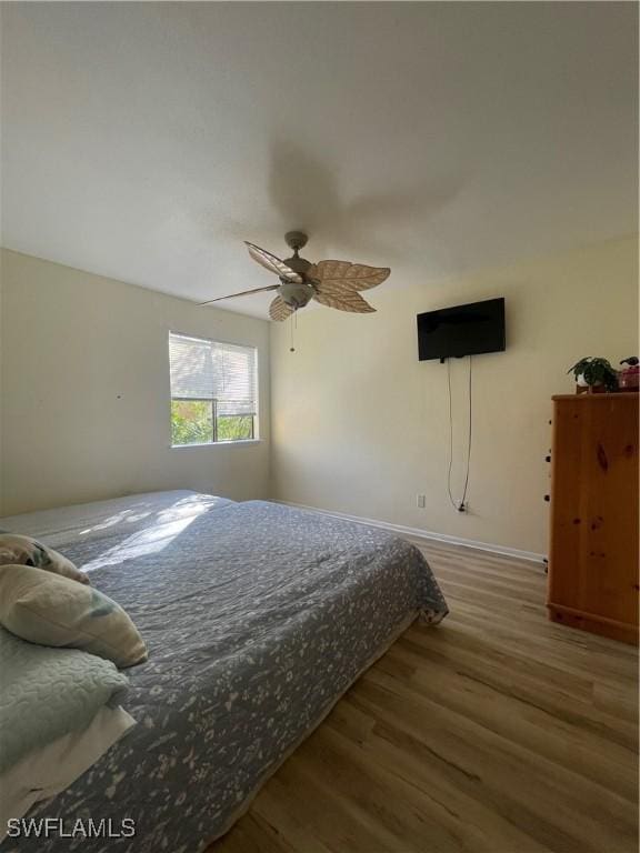 bedroom with wood-type flooring and ceiling fan