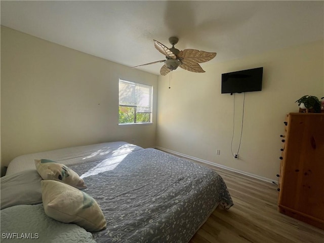 bedroom featuring dark wood-type flooring and ceiling fan