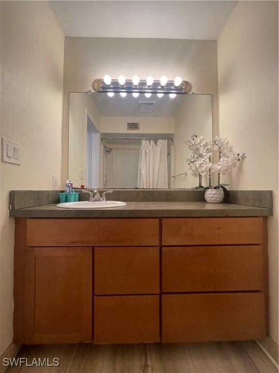 bathroom with vanity and hardwood / wood-style floors