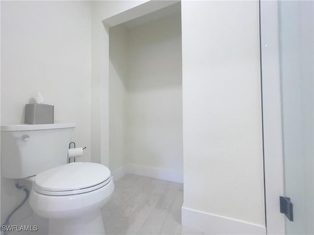 bathroom with wood-type flooring and toilet