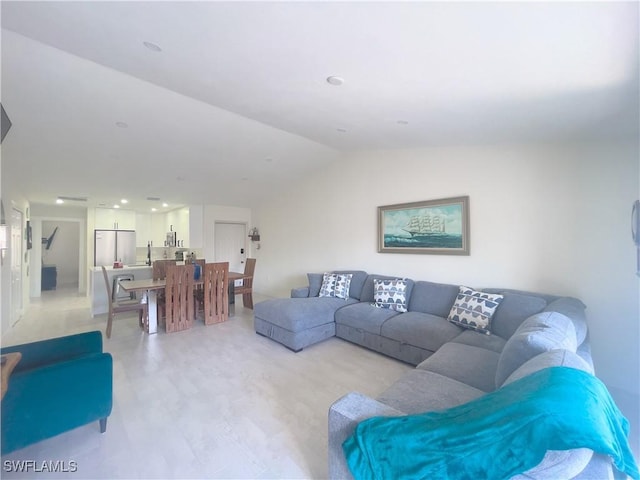 living room featuring lofted ceiling