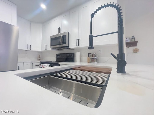 kitchen with stainless steel appliances and white cabinets