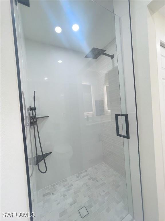 bathroom with a shower with shower door