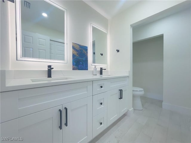 bathroom featuring vanity and toilet