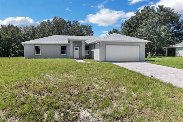 ranch-style house featuring a garage and a front yard