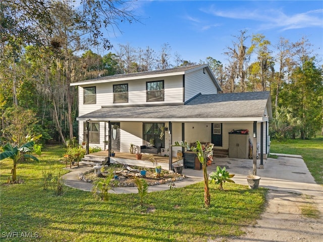 rear view of property with a yard and covered porch