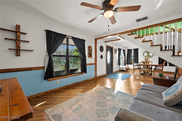 living room with hardwood / wood-style flooring and ceiling fan