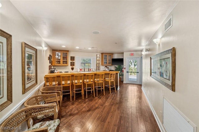 bar with dark wood-type flooring