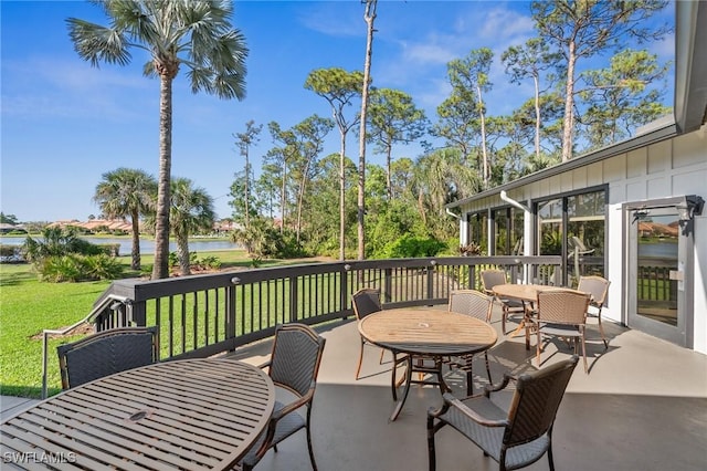 view of patio featuring a deck with water view