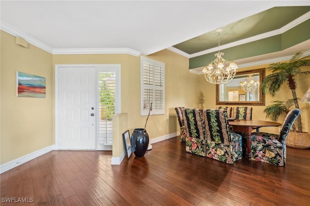 dining area featuring ornamental molding, a chandelier, and hardwood / wood-style floors