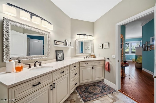 bathroom with vanity and wood-type flooring