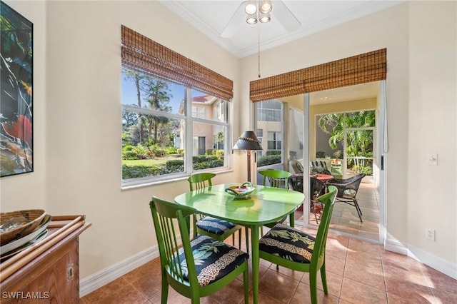 tiled dining area featuring ornamental molding and ceiling fan