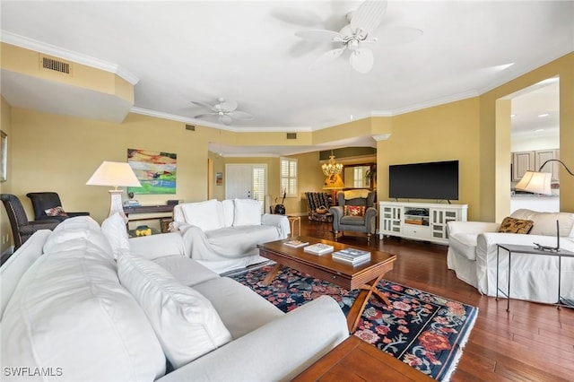 living room featuring ornamental molding, dark hardwood / wood-style floors, and ceiling fan with notable chandelier