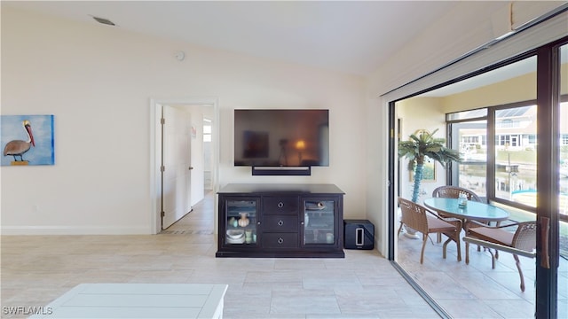 tiled living room with vaulted ceiling