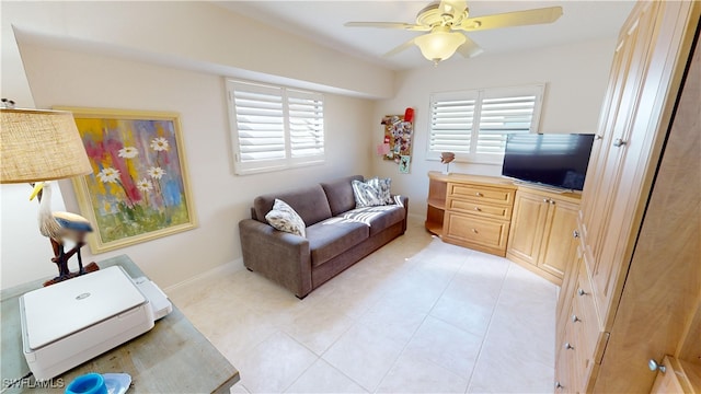 living room featuring ceiling fan and light tile patterned flooring