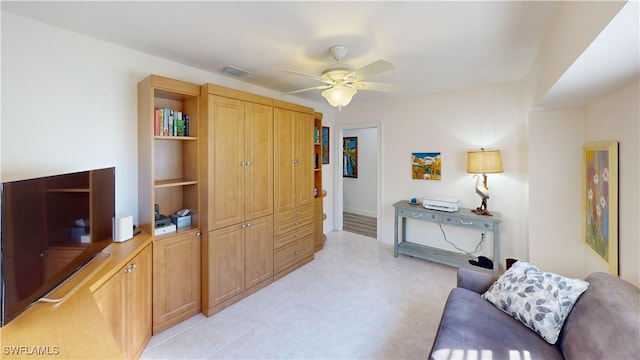 living area featuring light tile patterned flooring and ceiling fan