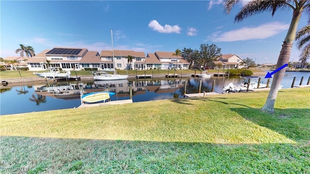 dock area with a water view and a yard