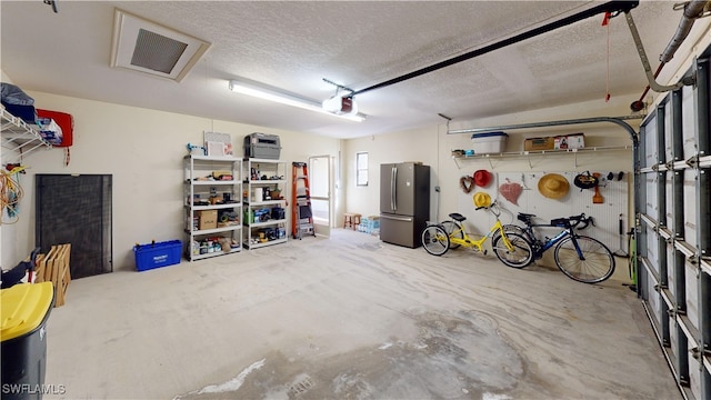 garage featuring a garage door opener and stainless steel fridge