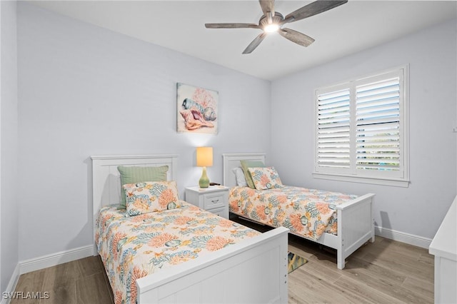 bedroom with ceiling fan and light wood-type flooring