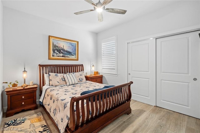 bedroom with ceiling fan, light hardwood / wood-style floors, and a closet